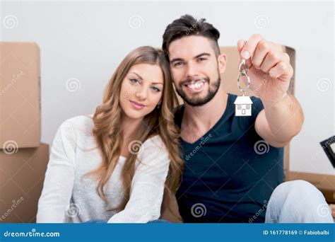 Young Couple Holding Their New House Keys Stock Image - Image of home