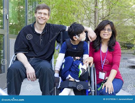 Disabled Child In Wheelchair With His Parents Royalty Free Stock Image