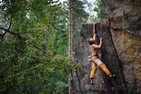Extreme Sport Climbing Young Male Rock Climber Reaching The Top Of A
