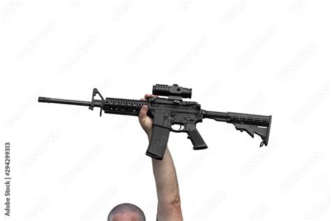 Man Holding Ar 15 Or Ar 16 Automatic Assault Rifle In Air Above His