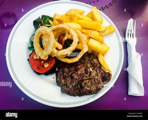 Rump Steak With Chips Onion Rings And Side Salad Stock Photo Alamy