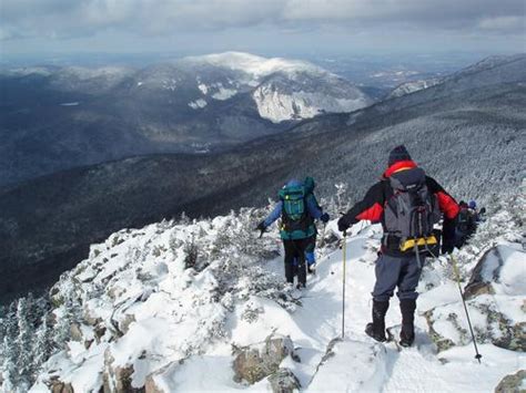 Filehikers Descending A Snow Capped Cannon Mountain In