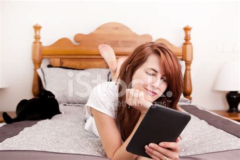 Woman Lying In Bed Reading An Electronic Book Stock Photo Royalty Free Freeimages