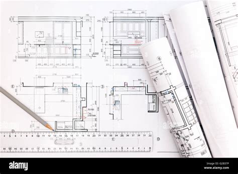 Architectural Blueprints And Blueprint Rolls With Pencil And Ruler