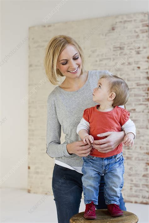 Mother Holding Baby Daughter On Stool Stock Image F0100948