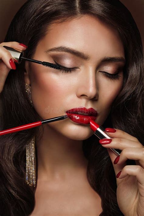 make up artist apply red lipstick part of attractive woman s face with fashion red lips makeup