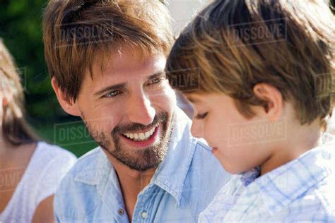 Father And Son Talking Together Outdoors Stock Photo Dissolve