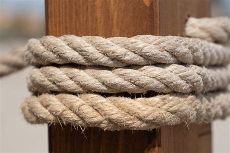 Close Up And Texture Of A Twisted Hemp Rope Wrapped Around A Wooden