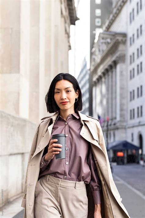Confident Asian Businesswoman Walking Outdoors By Stocksy Contributor