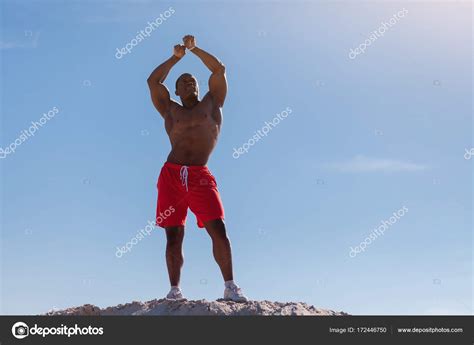 Muscular Man Flexing Biceps Stock Photo By ©romanlisovy 172446750