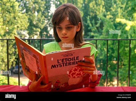 french girl reading book tintin l etoile mysterieue herge verneuil sur seine ile de france