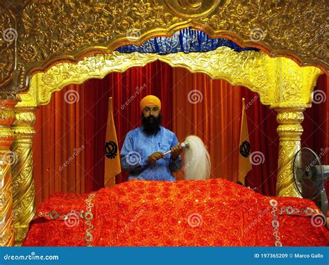 A Sikh At The Altar With The Holy Book In The Main Prayer Hall Of The