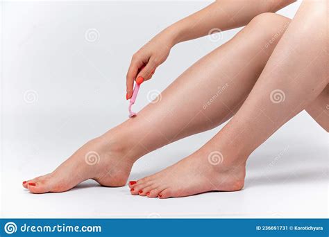 Beautiful Woman Shaves Her Legs On A White Background Stock Image Image Of Body Closeup