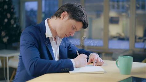 Guy Writing Notes Sitting At The Desk Stock Photo Image Of Window
