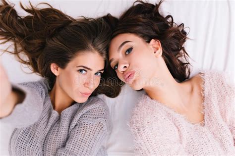 Chilling Time Of Two Attractive Models On Bed In Modern Apartment