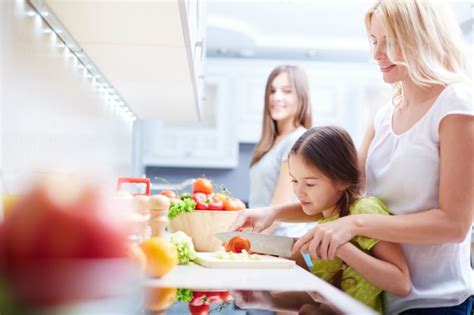 Mother Teaching Her Daughter How To Cook Photo Free Download