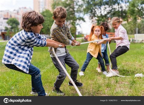 Kids playing tug of war — Stock Photo © ArturVerkhovetskiy  