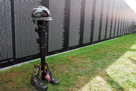 A Helmet Rifle Set Of Dog Tags And Pair Of Boots Called A Fallen