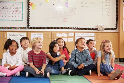 Elementary School Kids Sitting On Classroom Floor Stock Photo Dissolve