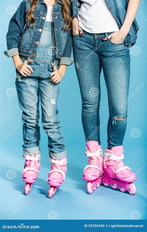 Low Section Of Mother And Daughter In Roller Skates In Studio Stock