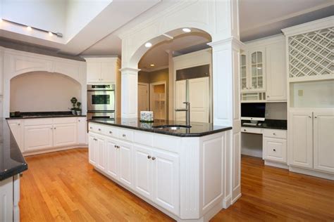 Crisp White Look With Nice Arches Over The Island And Stove Kitchen