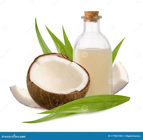 Coconut And Oil In Glass Bottle With Green Leaves Isolated On White