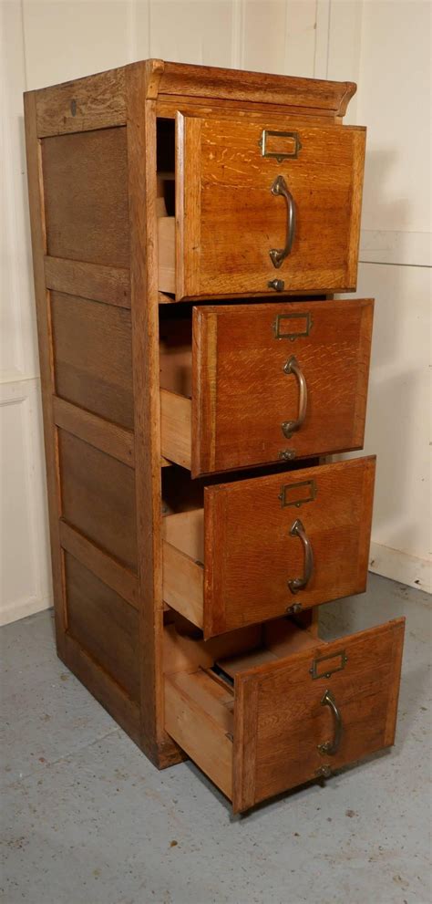 Organize your filing cabinet by getting rid of old files, finding a filing system that works for you, and continually maintaining it. Large Art Deco Four-Drawer Oak Filing Cabinet at 1stdibs