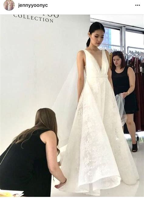 A Woman In A White Wedding Dress Getting Ready To Walk Down The Aisle