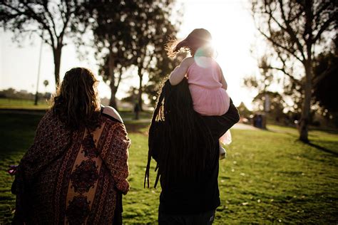 Niece On Uncles Shoulders Walking With Aunt And Sunset Photograph By