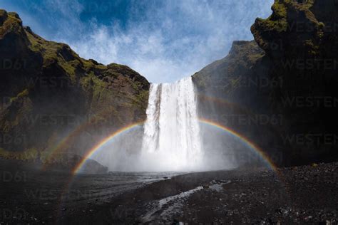 Breathtaking Scenery Of Rainbow Shining Over Rapid Powerful Skogafoss