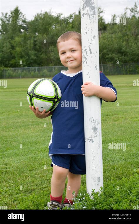 Young Boy Standing Behind Soccer Goal Post Stock Photo Alamy