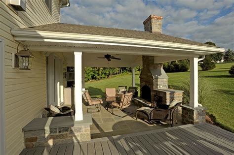 Covered Porch With Stone Hearth Fireplace And Attached Deck