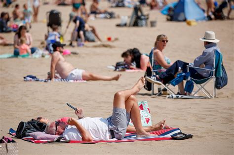 britons flock to beaches and parks for mini heatwave as temperatures soar amid warning over