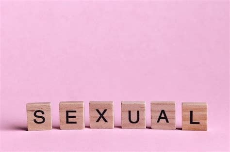 Premium Photo Sexual Words Represented By Wooden Letter Tiles Isolated On Colour Background