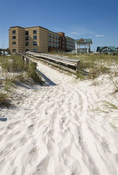 Path On Sand Heading To A Boardwalk In The Middle Of Sand Dunes At The
