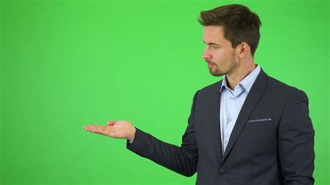 Green Screen Chroma Key A Young Handsome Businessman Puts Out A