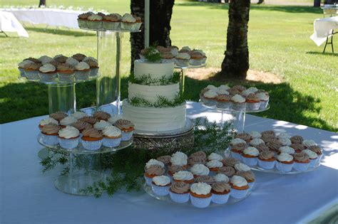 Cake And Cupcake Wedding ~ 3 Tiered Round Wedding Cake Surrounded By