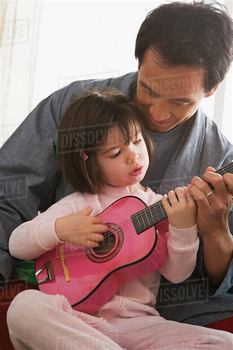 Father And Daughter Playing Guitar Stock Photo Dissolve