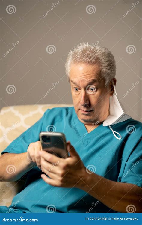 Photo Of A Doctor Shocked While Reading A Phone Text Message Stock Photo Image Of Reading