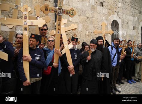 Serbian Pilgrims Wait Against The Wall Of The Via Dolorosa Alley With