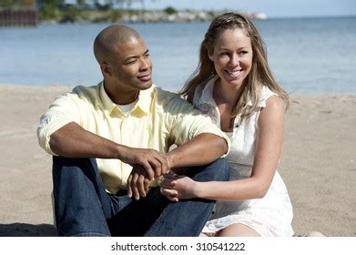 Happy Interracial Couple Sitting Beach On Stock Photo 310541222