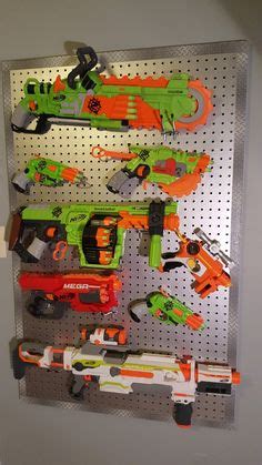 Make this easy diy nerf gun storage rack out of pvc pipe to hang them all in one place! Nerf gun wall display. This was made from slat wall board ...