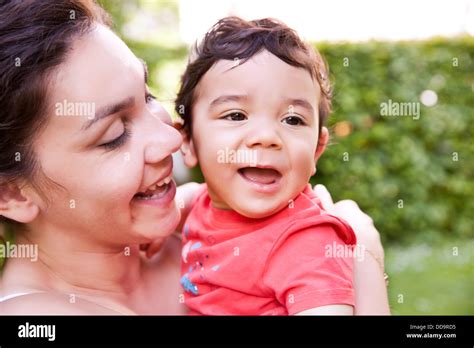 Mother Cuddling Her Baby Boy Smiling Stock Photo Alamy