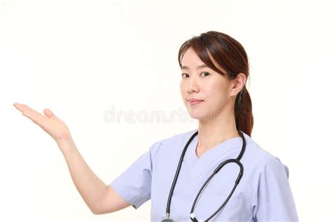 Japanese Female Doctor Presenting And Showing Something Stock Image