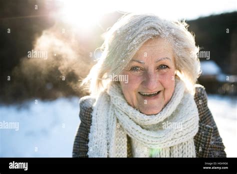 Beautiful Senior Woman On A Walk Covered By Snow Stock Photo Alamy