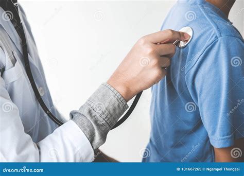Doctor Checking Patient With Stethoscope Listening To Heartbeat