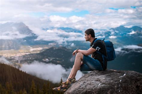 Young Man Sitting On The Cliff Of The Mountain Pixahive