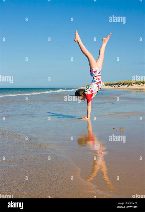 Little Girl Doing Handstand On Beach Photo Stock Alamy