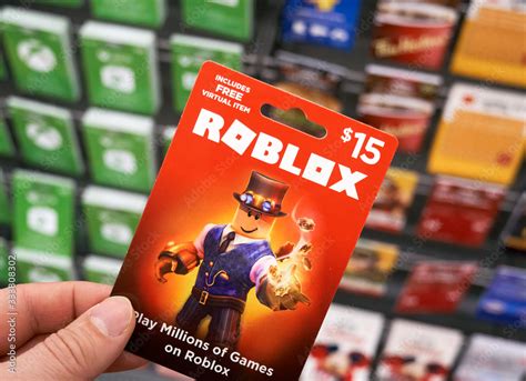 Roblox Gift Card In A Hand Over Gift Cards Background Stock Foto