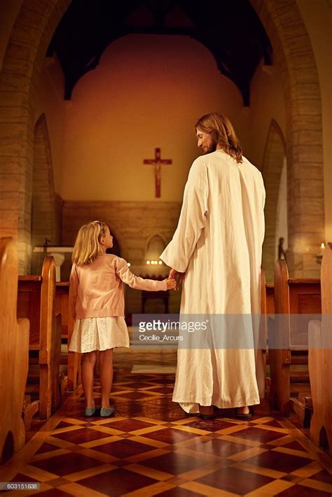 Cropped Shot Of A Little Girl Holding Hands With Jesus While Standing